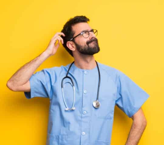 Surgeon Doctor Man Having Doubts While Scratching Head